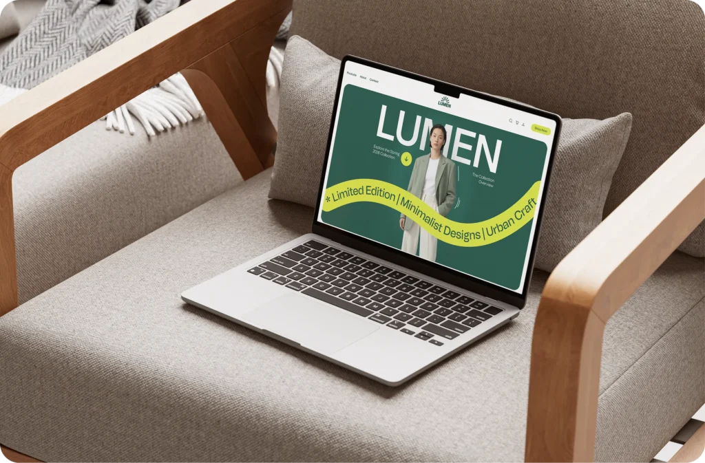A laptop on an armchair showing the Lumen fashion website