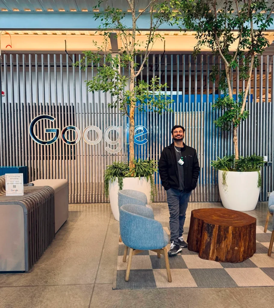 Waqar Hussain, Icon Pro Solutions CEO, standing in an office lobby beside a large Google sign