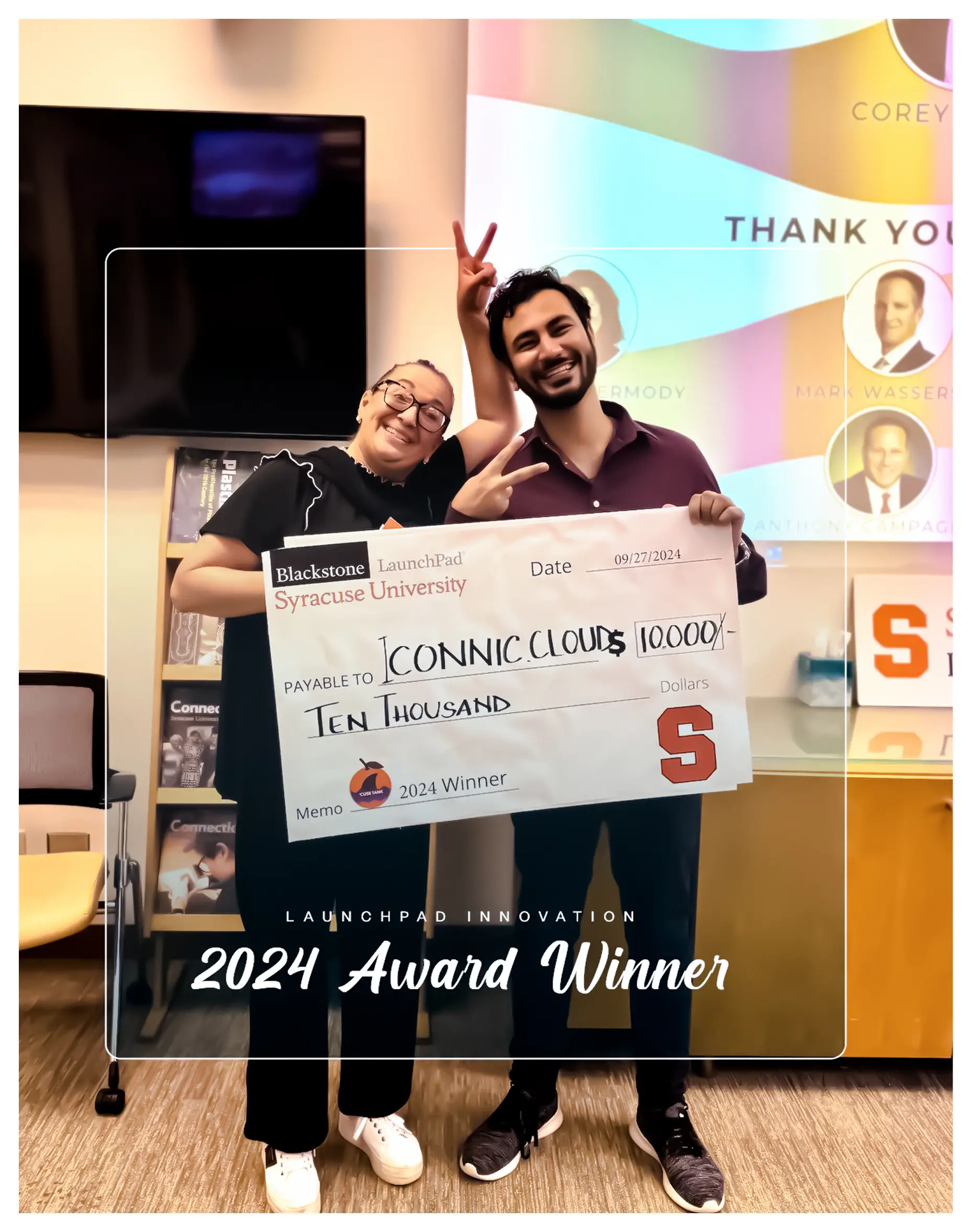 Two people holding a Blackstone LaunchPad Syracuse University check for 10,000 dollars, captioned 2024 Award Winner