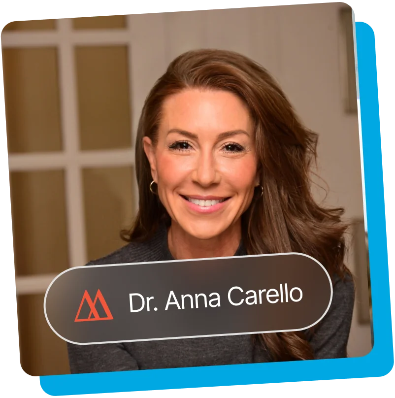 Dr. Anna Carello smiling, in a gray sweater
