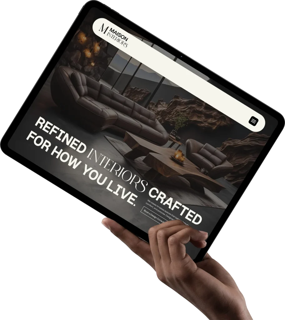 Tablet held in a hand showing a website design