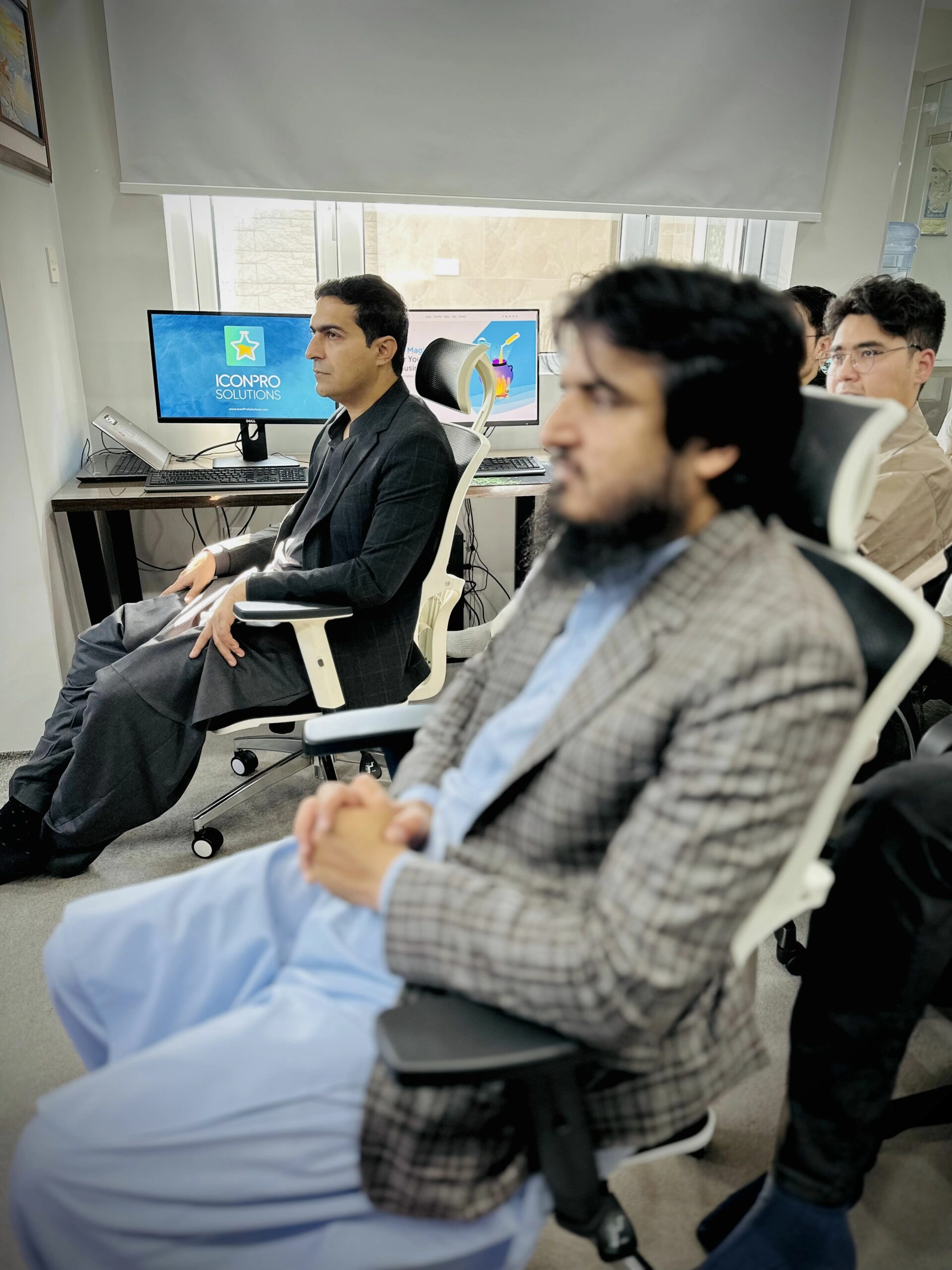 Dean of FICT and BUITEMS lecturer captured in the audience at an Icon Pro Solutions event, embodying academic partnership.